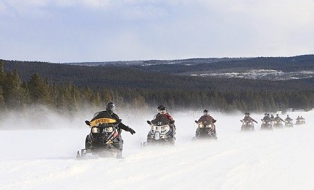 Image by 272447 from Pixabay of people snowmobiling